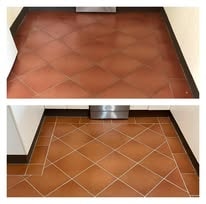 Kitchen floor tiles before — worn cracked grout